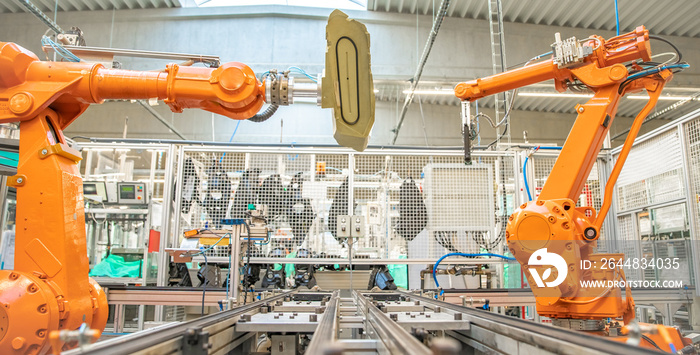 orange robot arms on the production line. controlled by a computer with artificial intelligence