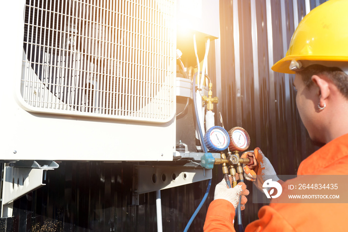 A professional air conditioner technician checking the refrigerant.