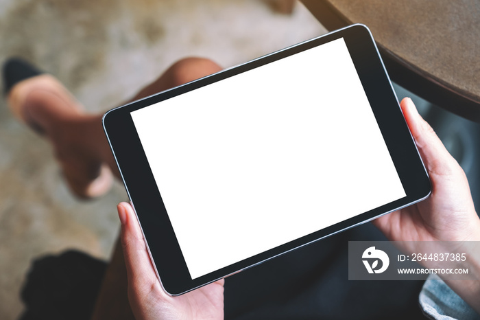 Top view mockup image of a woman holding black tablet with white blank screen