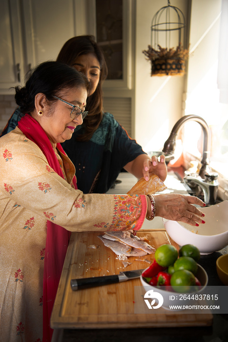 Daughter teaching daughter in the kitchen