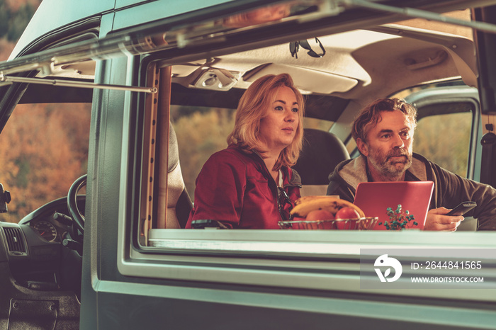 Couple Watching Exciting TV Game Inside Camper Van RV