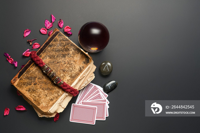 Accessories of fortune teller on dark background