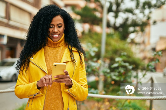 Middle age african american woman using smartphone at the city.