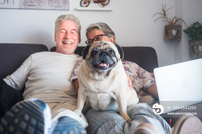 Funny family concept with couple of cheerful caucasian people senior man and woman sit down on the s