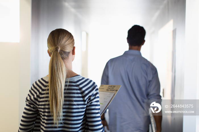 Business people walking in office corridor