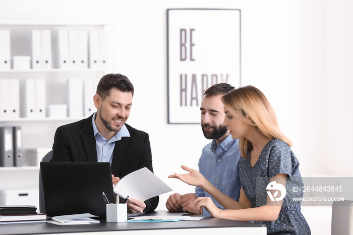 Businessman consulting young couple in office