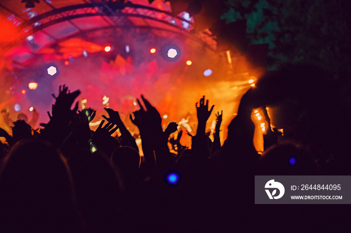 Abstract blur atmosphere: happy people enjoying outdoor music festival concert, raised up hands and 