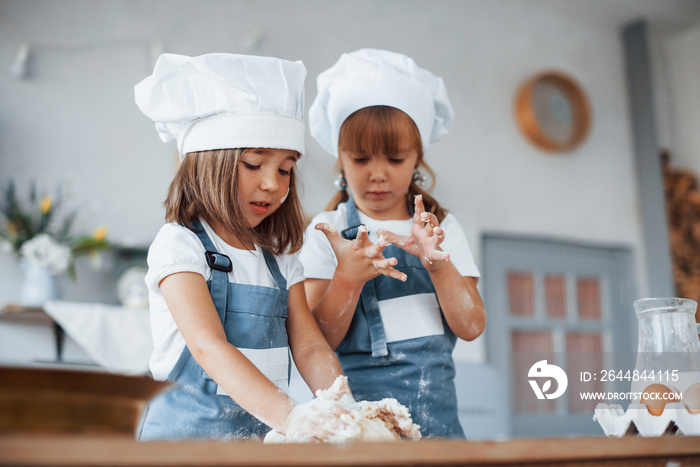 穿着白色厨师制服的家庭孩子在厨房准备食物