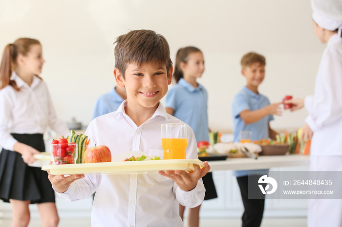 Schoolboy having lunch in school canteen