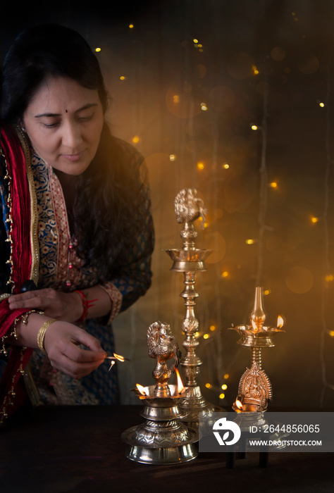 Woman lighting lamp