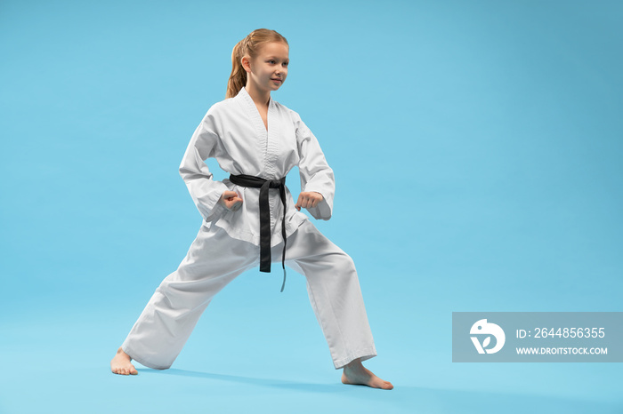 Girl performing defense position of karate.