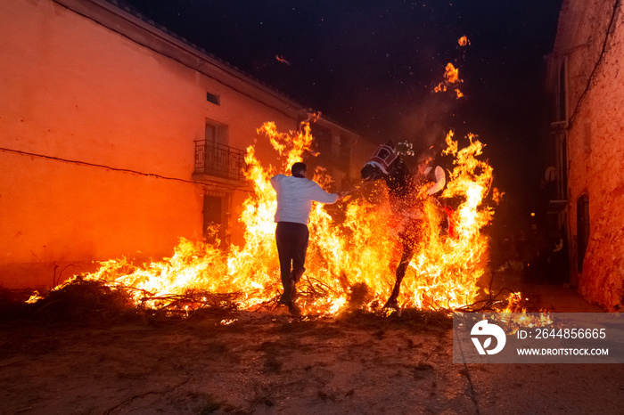 Men rides his horse through the fire in the traditional celebration of Saint Anthonys day in the sm