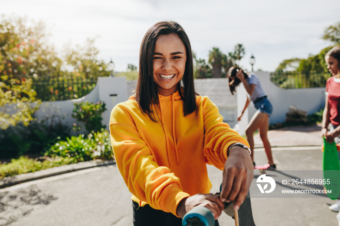 Girls skating in the street on a sunny day