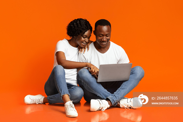 Relaxed african american couple using laptop together