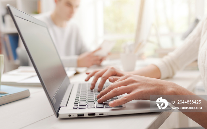 Woman using a laptop and connecting