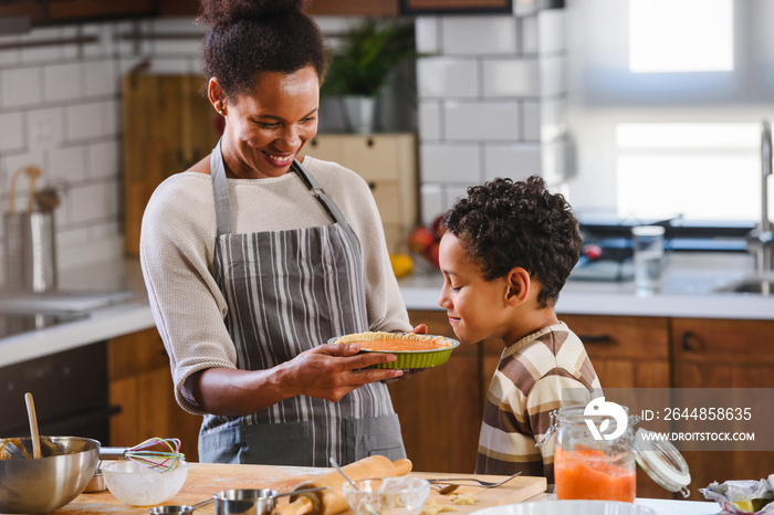 Mother has baked pumpkin pie for her son