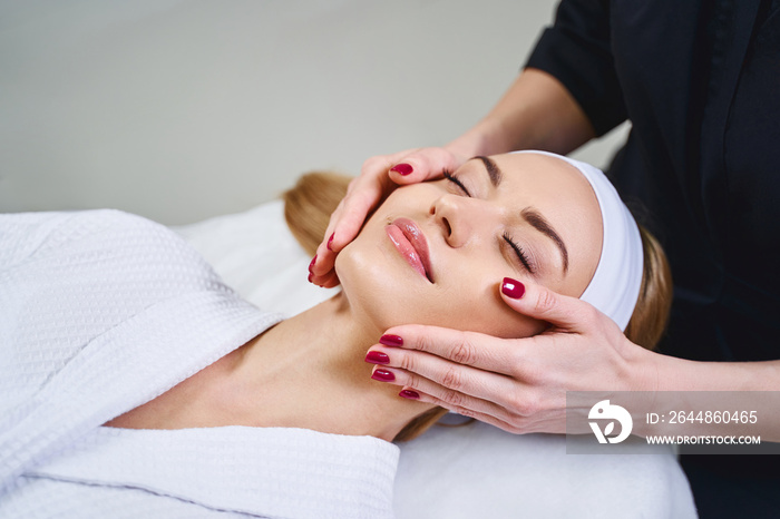 Happy woman enjoying beauty procedures stock photo