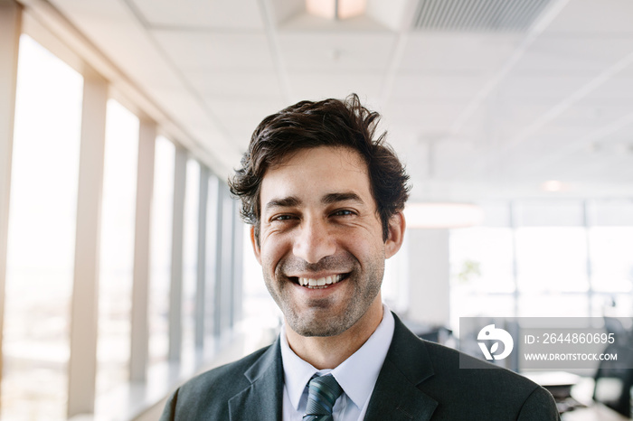 Successful young businessman standing in office