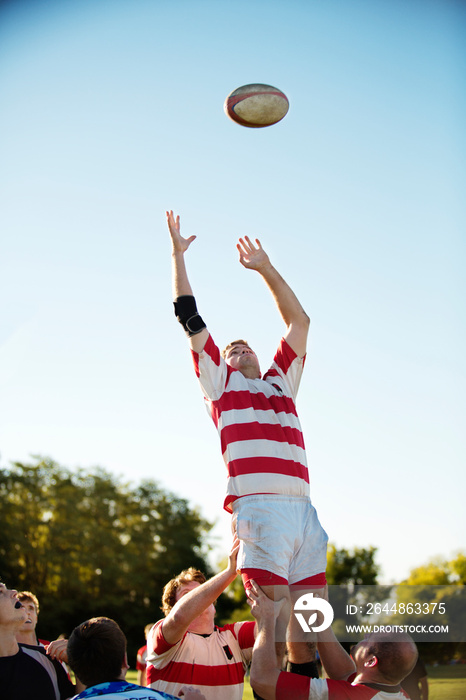 Rugby player catching ball outdoors