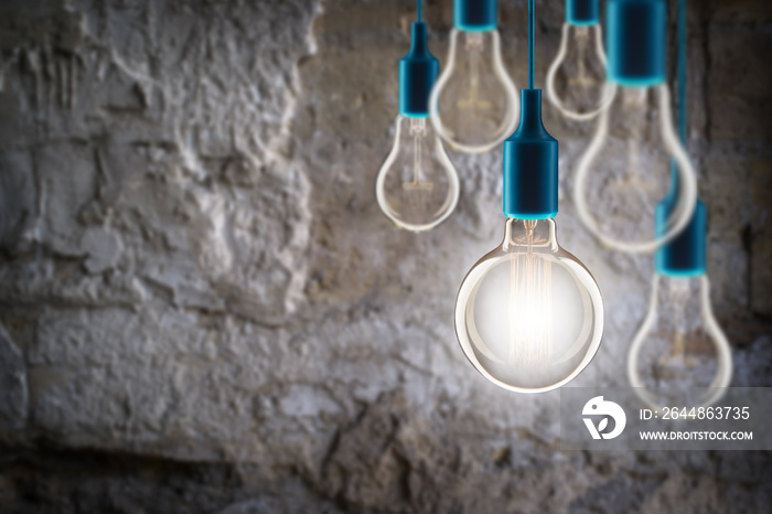 Idea and teamwork concept - Vintage incandescent bulbs on the grunge background