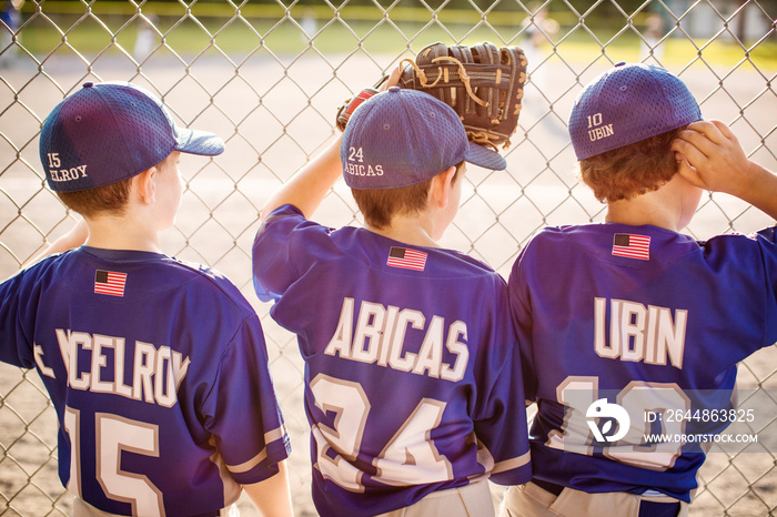 Rear view of baseball players looking at field