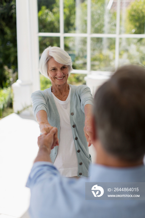 Senior couple dancing on patio