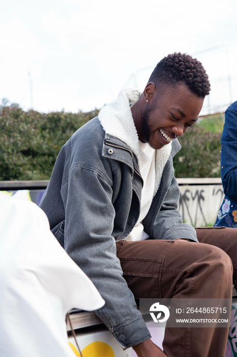 Black trans man laughing.