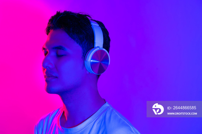 Music streaming services. Portraif of smiling handsome asian man in wireless headphones enjoying his