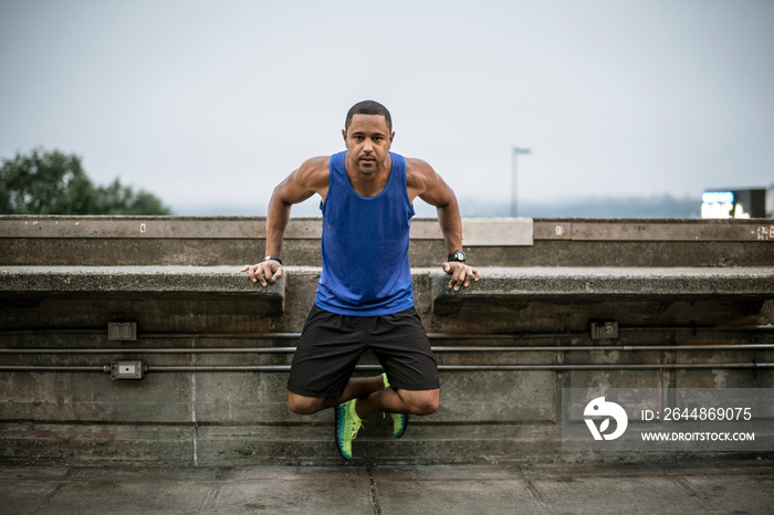 Portrait of man exercising at bridge