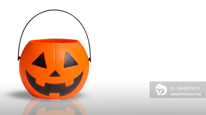 Traditional Jack-o-lantern bucket for celebration Halloween. Orange pumpkin scary smile face Jack-o-