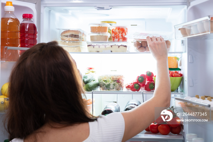 Woman Taking Food From Refrigerator