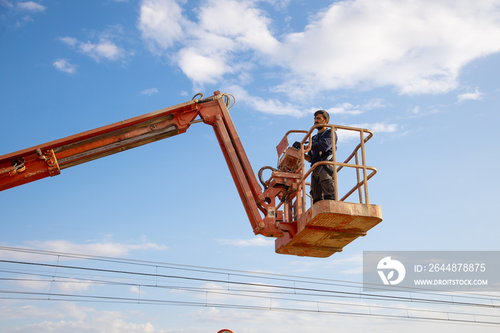 man working at heights with lifting platform.