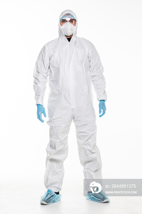 Young man in chemical protective suit making stop gesture on white background. Virus research