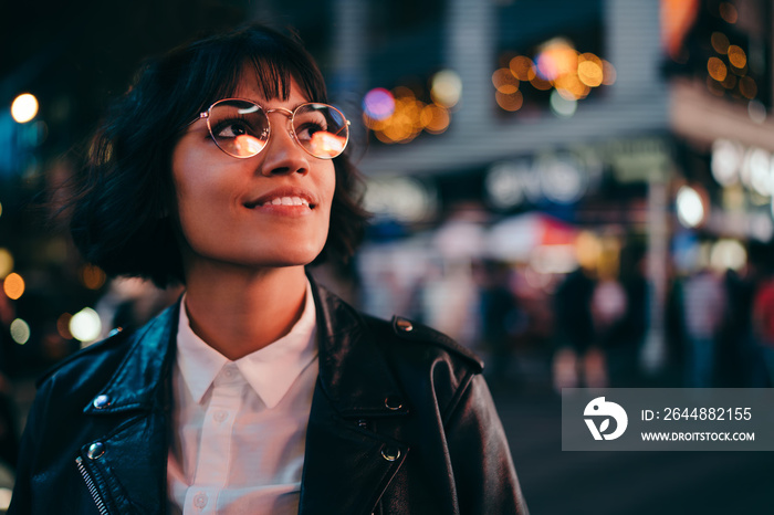 Carefree brunette young woman with short haircut in stylish eyewear for eyes protection fascinated w