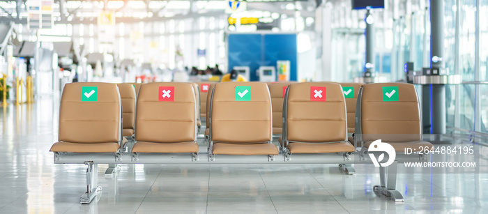 Symbol sticker on chair in international airport. New Normal and social distancing concepts, protect