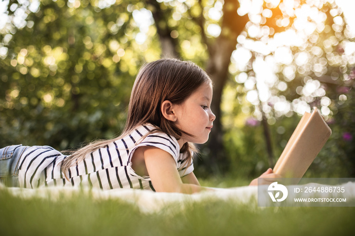 Little girl resting at park in summer