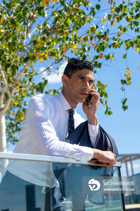 Businessman talking on phone outdoors