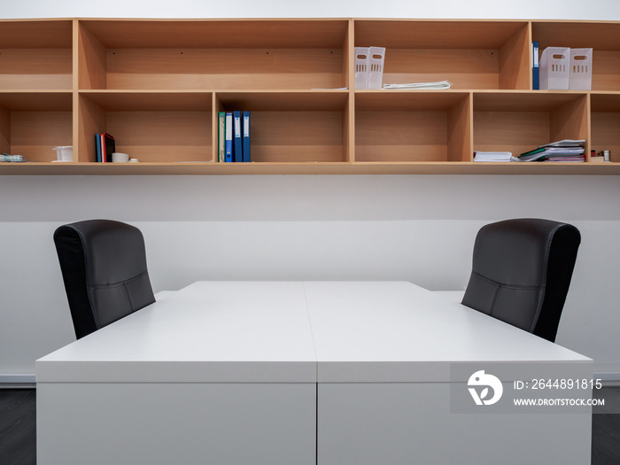 Small office interior with wooden shelving