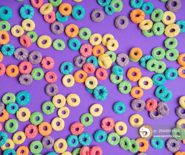 Colorful cereal  on a purple  background