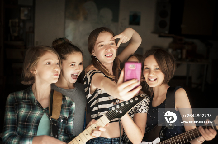 Girls (10-11,  12-13) taking selfie with instruments