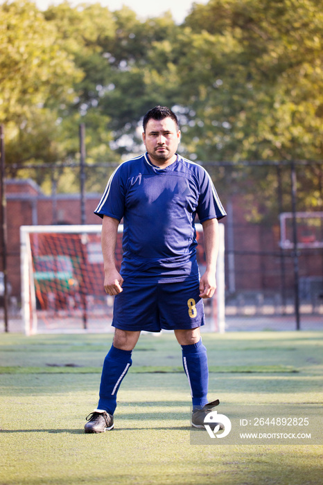 Soccer player standing in sports field