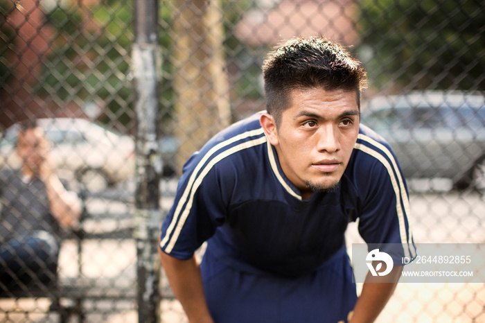 Young man standing in soccer field