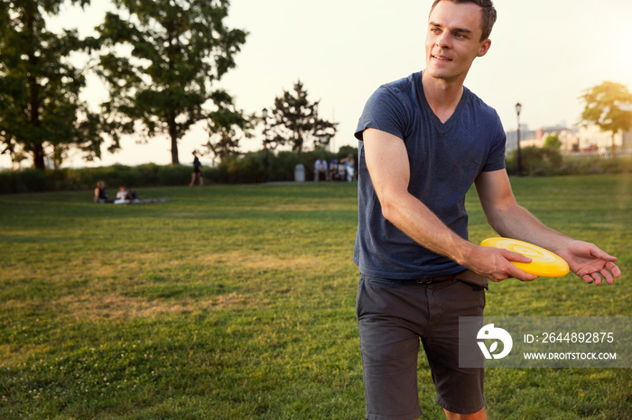 Young man throwing plastic disc