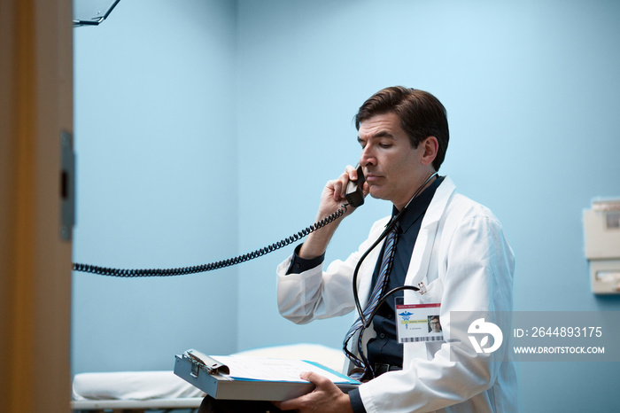 Side view of male doctor talking on phone