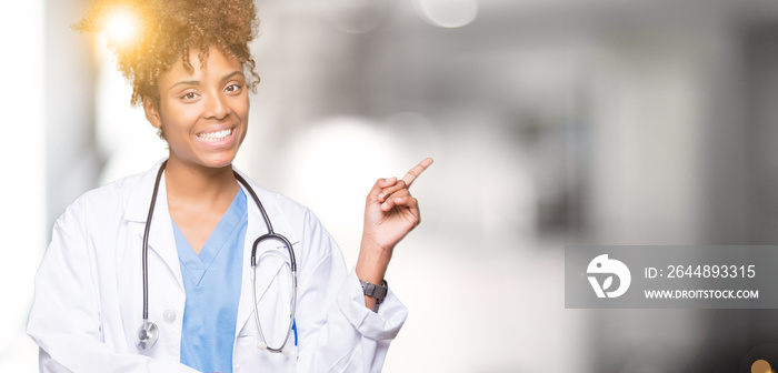 Young african american doctor woman over isolated background with a big smile on face, pointing with