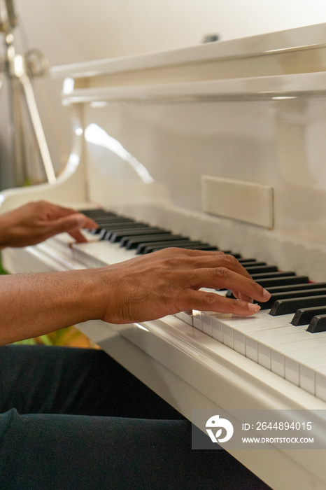 UK, London,�Close-up�of hands of man playing piano