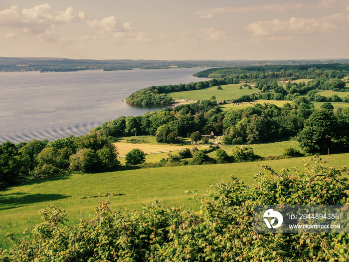 Lough Derg county Tipperary, Landscape, sunny day, lake shore, green fields, cloudy sky. Country sid