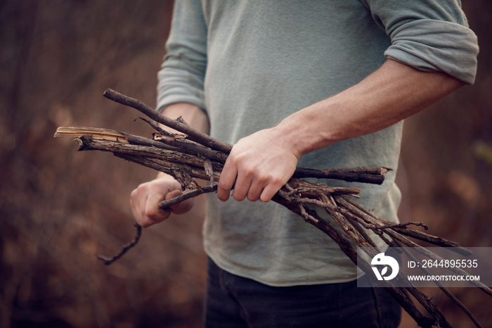 Young man collecting firewood