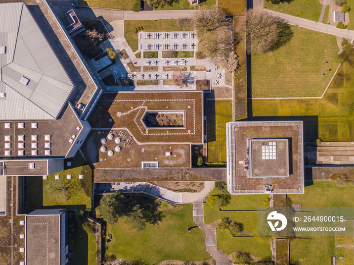 Aerial view of university buildings. Overhead shot of building roofs in park environment.