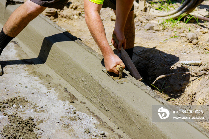 The process of construction of the sidewalk, the installation of a curb